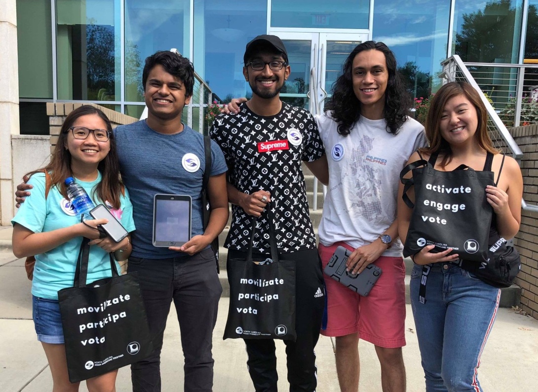 A group of young asian voters outside their polling place